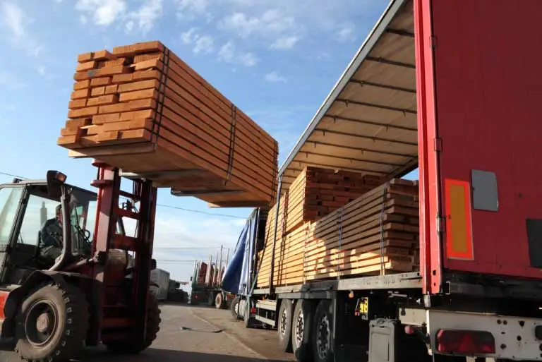 wood planks being stacked in a container.