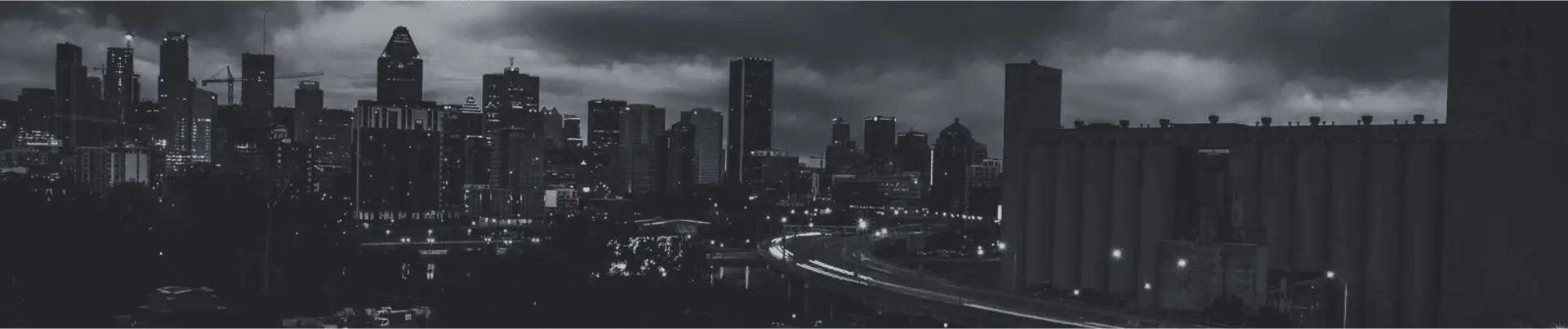 A city landscape showcasing numerous buildings and a highway.